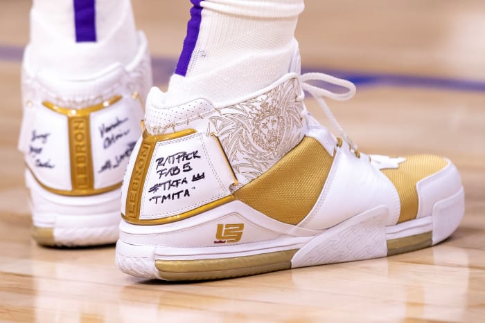 View of LeBron James' white and gold Nike shoes.